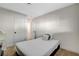 A minimalist bedroom featuring a twin bed, neutral carpet, and ample closet space at 1500 Saylor Way, Las Vegas, NV 89108
