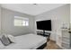 Cozy bedroom with a window providing natural light and featuring a television and record player on a shelf at 1500 Saylor Way, Las Vegas, NV 89108