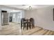 Well-lit dining area featuring hardwood flooring and a view of the stainless-steel refrigerator at 1500 Saylor Way, Las Vegas, NV 89108