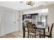 Dining room with a table and chairs, open to the kitchen area with modern appliances and decor at 1500 Saylor Way, Las Vegas, NV 89108