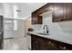 Modern kitchen featuring stainless steel appliances, dark wood cabinets, and white countertops at 1500 Saylor Way, Las Vegas, NV 89108