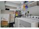 Laundry room featuring a white washer and dryer, white shelving and storage solutions at 1500 Saylor Way, Las Vegas, NV 89108