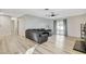 Spacious living room with hardwood floors, modern ceiling fan, and sliding glass doors at 1500 Saylor Way, Las Vegas, NV 89108