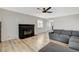 Spacious living area with hardwood floors, a gray sectional sofa, and a modern fireplace at 1500 Saylor Way, Las Vegas, NV 89108