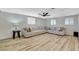 Living room featuring a large sectional sofa, wood floors, and windows providing natural light at 1500 Saylor Way, Las Vegas, NV 89108