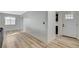 Bright living room featuring light wood floors, white walls, and a window offering natural light at 1500 Saylor Way, Las Vegas, NV 89108