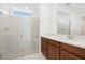 Bright bathroom featuring a glass-enclosed shower with tile surround and a vanity with quartz countertop at 2255 Woodbluff Ave, North Las Vegas, NV 89086