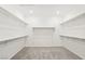 Bright walk-in closet with carpet and shelving system for ample storage at 2255 Woodbluff Ave, North Las Vegas, NV 89086