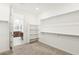 Walk-in closet with shelving system, and a glimpse into the bathroom at 2255 Woodbluff Ave, North Las Vegas, NV 89086