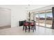 Bright dining area with tile floors, a chandelier, a black table, and sliding glass doors to the patio at 2255 Woodbluff Ave, North Las Vegas, NV 89086