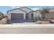 Lovely single-story home with desert landscaping, a paved driveway, and a two-car garage at 2255 Woodbluff Ave, North Las Vegas, NV 89086