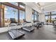Modern gym with treadmills and stationary bikes offering views of palm trees and the community pool at 2255 Woodbluff Ave, North Las Vegas, NV 89086