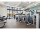 Community gym with modern equipment and large windows overlooking palm trees and the pool at 2255 Woodbluff Ave, North Las Vegas, NV 89086