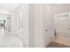 Bright hallway with tile floors leading to a living area and bathroom at 2255 Woodbluff Ave, North Las Vegas, NV 89086