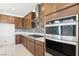 Gourmet kitchen featuring stainless steel appliances, a gas range, and sleek countertops at 2255 Woodbluff Ave, North Las Vegas, NV 89086