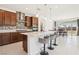 Eat-in kitchen features a large island with seating, stainless steel appliances, and a backsplash at 2255 Woodbluff Ave, North Las Vegas, NV 89086