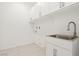Laundry room with a sink, cabinet, and white walls at 2255 Woodbluff Ave, North Las Vegas, NV 89086