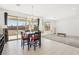 Open floor plan combining dining area and living room with large windows and sliding glass doors to the patio at 2255 Woodbluff Ave, North Las Vegas, NV 89086