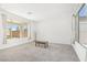 Bright living room featuring large windows with backyard views and neutral carpeting at 2255 Woodbluff Ave, North Las Vegas, NV 89086