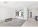 Open living space with large windows, neutral walls, and tile flooring leading to the kitchen and dining area at 2255 Woodbluff Ave, North Las Vegas, NV 89086