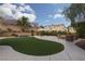 Spacious backyard with artificial lawn, seating, and outdoor dining area, perfect for gatherings at 23 Crescent Palm Ct, Henderson, NV 89002