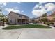 Expansive backyard with manicured lawn, pool, patio, and mature palm trees, ideal for outdoor living at 23 Crescent Palm Ct, Henderson, NV 89002