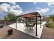 Backyard featuring a gazebo with a table and chairs, a fire pit, a pool, and a lawn at 23 Crescent Palm Ct, Henderson, NV 89002