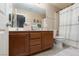 A well-lit secondary bathroom features a double sink vanity, tile floors, and a shower/tub combo at 23 Crescent Palm Ct, Henderson, NV 89002