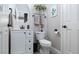 Modern bathroom with white vanity, round mirror, toilet, and decorative accents at 23 Crescent Palm Ct, Henderson, NV 89002