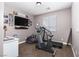 Neutral-toned bedroom with exercise equipment, desk and chair at 23 Crescent Palm Ct, Henderson, NV 89002