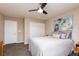 Cozy bedroom with a queen bed, ceiling fan, double closets, and soft, neutral tones at 23 Crescent Palm Ct, Henderson, NV 89002