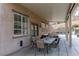 Relaxing covered patio with outdoor dining and seating area overlooking backyard pool at 23 Crescent Palm Ct, Henderson, NV 89002