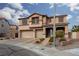 Charming two-story home featuring a three-car garage, landscaped front yard, and inviting front porch at 23 Crescent Palm Ct, Henderson, NV 89002