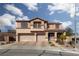 Charming two-story home featuring a three-car garage, landscaped front yard, and inviting front porch at 23 Crescent Palm Ct, Henderson, NV 89002