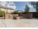 Backyard stone fire pit with built-in seating, creating an inviting outdoor gathering space at 23 Crescent Palm Ct, Henderson, NV 89002