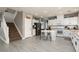 Well-lit kitchen features stainless steel appliances, a central island, and stairs to the upper level at 23 Crescent Palm Ct, Henderson, NV 89002