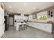 Bright and spacious kitchen featuring white cabinetry, stainless steel appliances, and modern countertops at 23 Crescent Palm Ct, Henderson, NV 89002