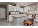 Bright kitchen featuring stainless steel appliances, tile backsplash, and white cabinetry at 23 Crescent Palm Ct, Henderson, NV 89002