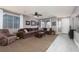 Spacious living room with comfortable seating, a ceiling fan, and an abundance of natural light at 23 Crescent Palm Ct, Henderson, NV 89002