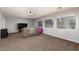 Spacious living room featuring large windows, plush carpeting, and a comfortable couch at 23 Crescent Palm Ct, Henderson, NV 89002
