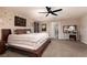 This spacious main bedroom features a ceiling fan, neutral-toned walls, and a walk-in bathroom for added convenience at 23 Crescent Palm Ct, Henderson, NV 89002