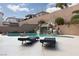 Inviting swimming pool with a rock waterfall feature and lounge chairs for a tranquil oasis at 23 Crescent Palm Ct, Henderson, NV 89002