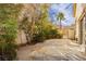 Private backyard oasis with stone patio and lush landscaping, perfect for outdoor entertaining at 2345 Cliffwood Dr, Henderson, NV 89074
