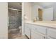 Modern bathroom featuring a glass enclosed shower, white vanity, and large mirror with stylish fixtures at 2345 Cliffwood Dr, Henderson, NV 89074
