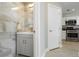 Stylish powder room with modern vanity, decorative tiling, and kitchen access at 2345 Cliffwood Dr, Henderson, NV 89074