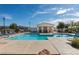 Resort style community pool with lounge chairs and covered seating area, perfect for relaxing in the sun at 2345 Cliffwood Dr, Henderson, NV 89074