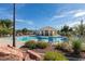 Resort style community pool with lounge chairs and covered seating area, perfect for relaxing in the sun at 2345 Cliffwood Dr, Henderson, NV 89074