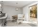 Dining area with a round table, white chairs, and sliding doors to the patio at 2345 Cliffwood Dr, Henderson, NV 89074