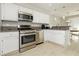 Bright kitchen with granite countertops, stainless appliances, and open to the dining area at 2345 Cliffwood Dr, Henderson, NV 89074