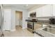 Kitchen with stainless steel appliances, granite counters, and easy access laundry area at 2345 Cliffwood Dr, Henderson, NV 89074